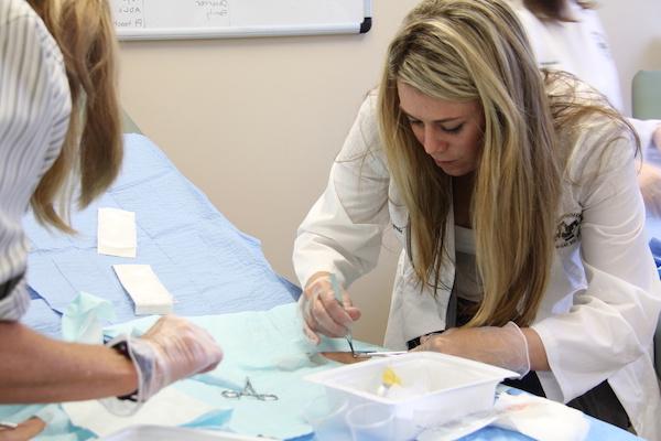 A nursing student practicing on a model.