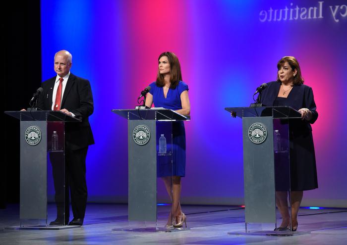 State Attorney's Debate with two women and one man debating on stage.